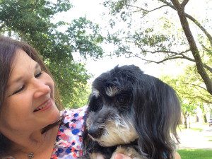 A woman holding a dog in her arms.
