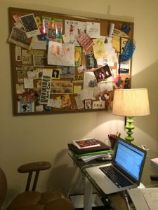 A laptop and lamp are on the desk.