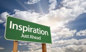 A green sign that says inspiration just ahead.