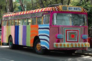 A colorful bus is driving down the street.